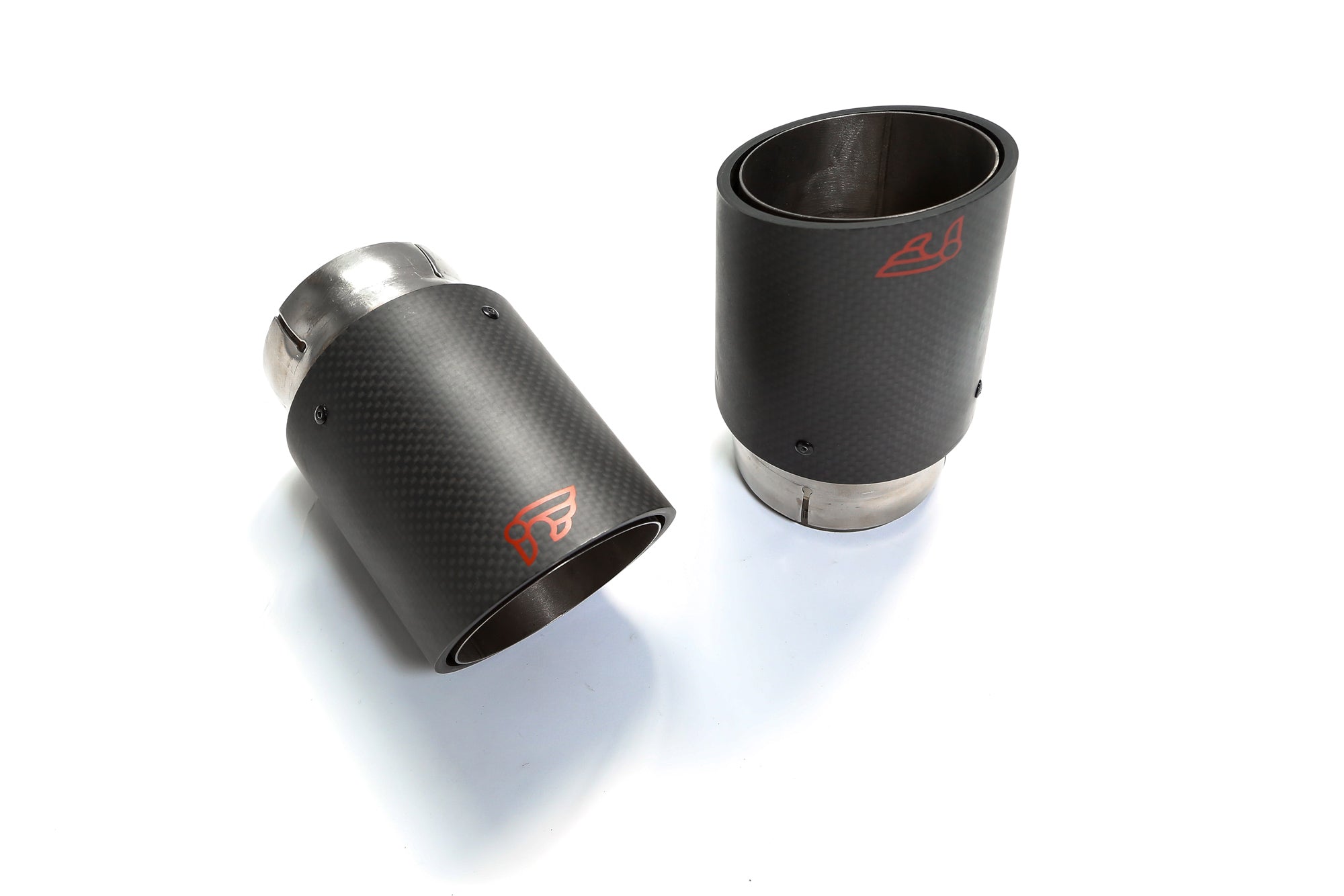 A top wide view of carbon fiber tips of the IPE SS Cat Back System with OBDII with Lighting Sensor for Audi S4 B9 / S5 F5 2017-2025 with white background