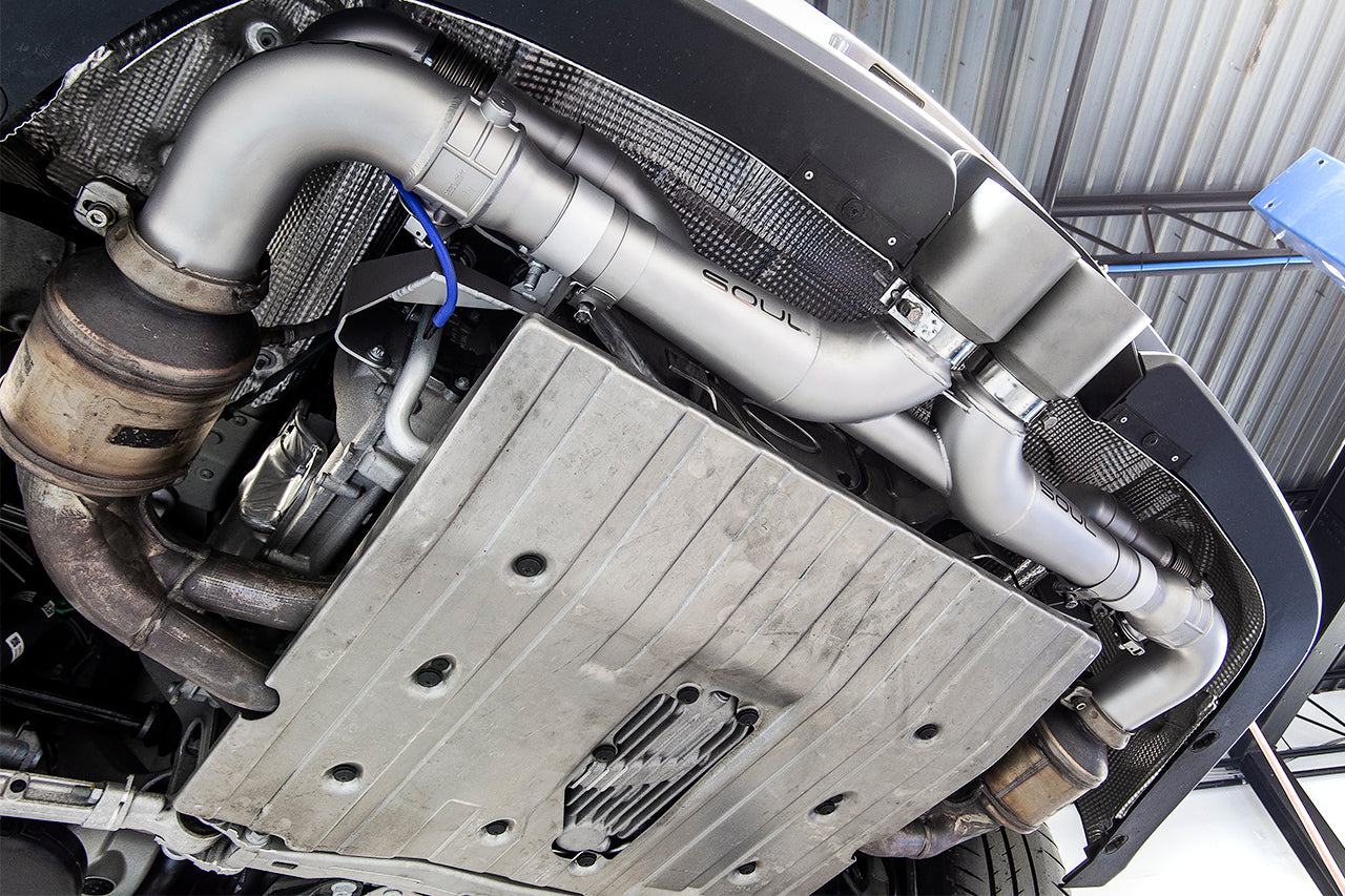 Soul 991 GT3 / GT3 RS side muffler bypass pipes: bracket installed under the rear of a GT3