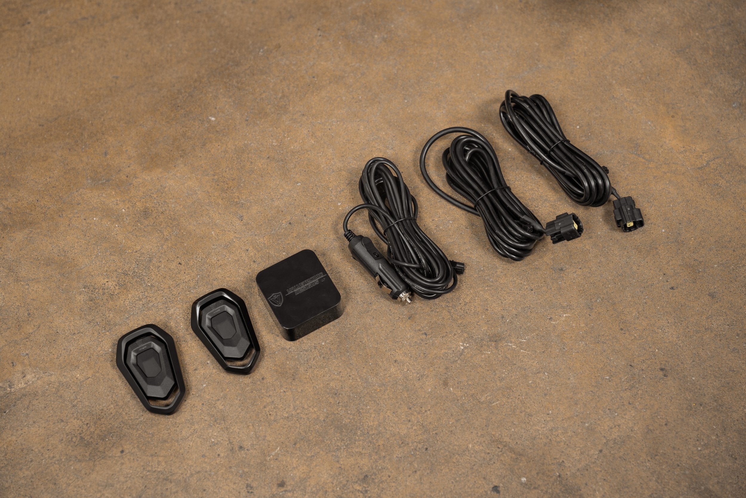 Two SHUTO key-fob remotes beside controller and coiled wiring harnesses