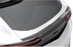 Carbon trunk spoiler on a white Lamborghini Urus SE tailgate, close-up