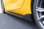 A close up view of Dinan Side Skirts for Toyota GR Supra 2020-2025 fitted on a yellow car on the road
