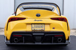 A back view of a yellow car fitted with Dinan Rear Diffuser for Toyota GR Supra 2020-2025 on the road