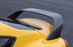 A back close up view of a yellow car fitted with Dinan High-Rise Rear Spoiler for Toyota GR Supra 2020-2025 on the road