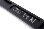 A top close up view of Dinan Strut Tower Braces for BMW with white background  with dinan logo on the brace