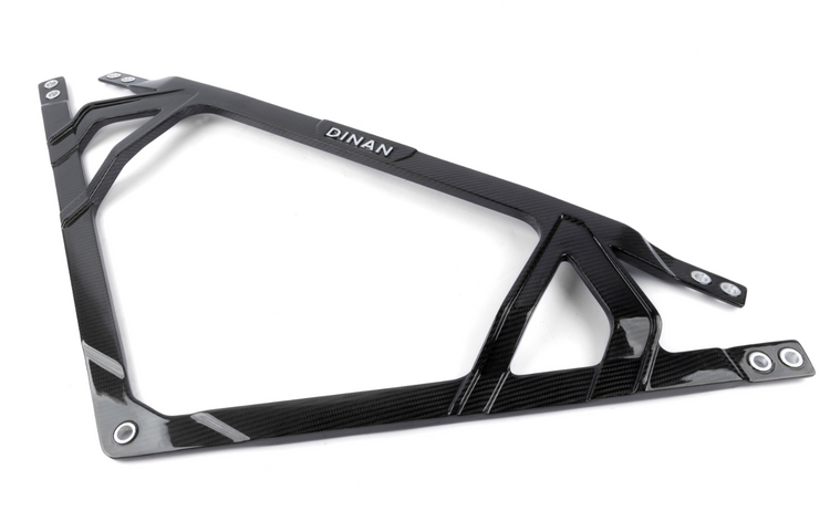 A top view of Dinan Carbon Fiber Strut Tower Brace for BMW M2 / M3 / M4 2021-2025 in gloss material with white background