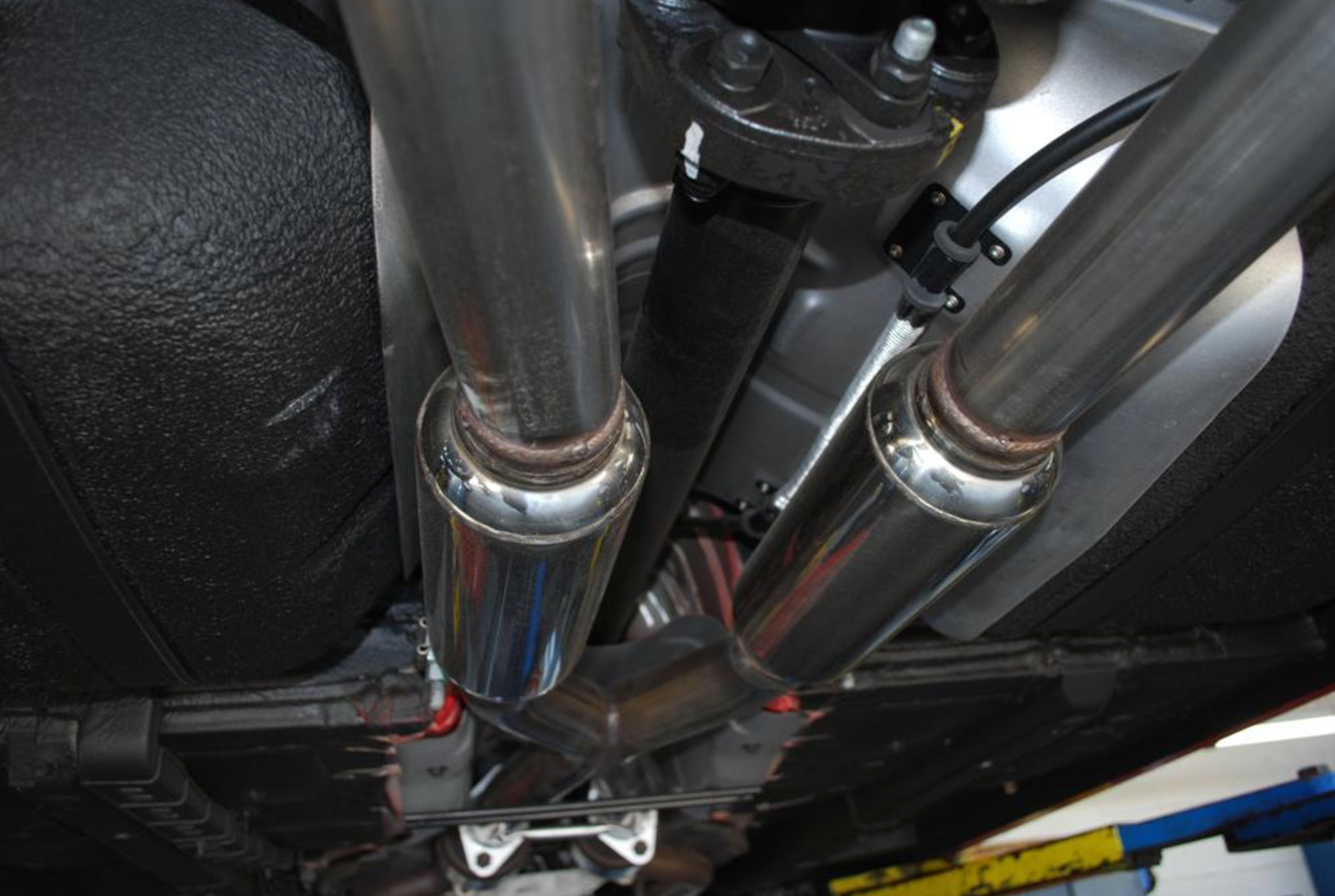 A close up view of Stillen Cat-Back Exhaust System for Hyundai Genesis Coupe [BK38] 2010-2016 fitted in a car from inside.