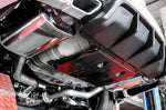 A close up view of Stillen Cat-Back Exhaust System for Nissan Maxima [3.5L] 2019-2023 fitted inside a lifted car