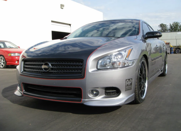 A wide front view of a car fitted with Stillen 5-Piece Body Kit for Nissan Maxima 2009-2015