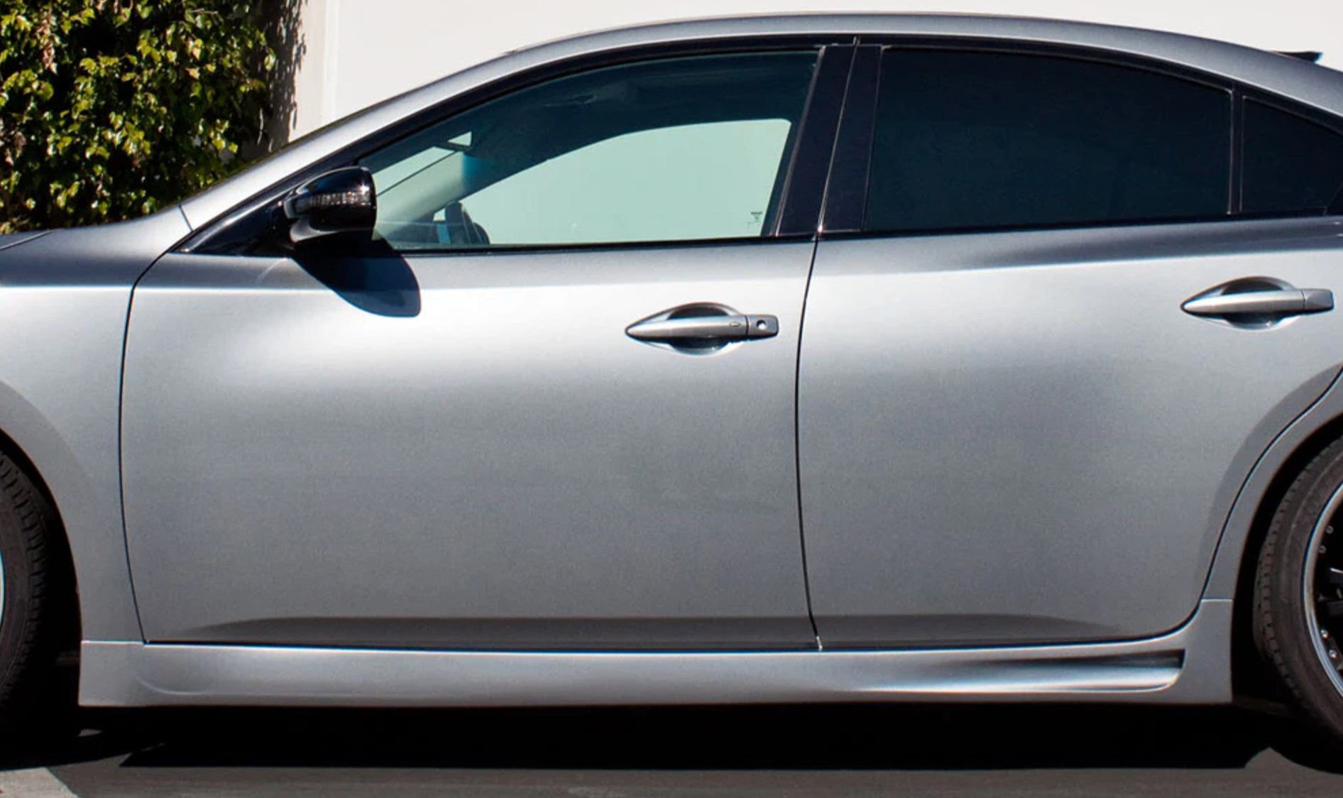 A close up side view of a car fitted with Stillen 5-Piece Body Kit for Nissan Maxima 2009-2015