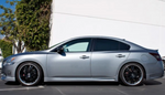 A side wide view of Stillen 7-Piece Body Kit for Nissan Maxima 2009-2015 fitted on a grey car