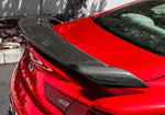 A back close up view of a red car fitted with Stillen Rear Spoiler [Carbon Fiber] for Infiniti Q60 2017-2022