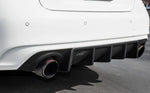 A back close up view of a white car fitted with Stillen Rear Diffuser [Matte Black] for Infiniti Q50 2018-2024 on the ground