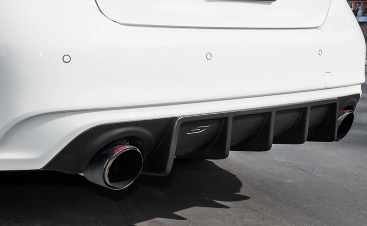 A back close up view of a white car fitted with Stillen Rear Diffuser [Matte Black] for Infiniti Q50 2018-2024 on the ground