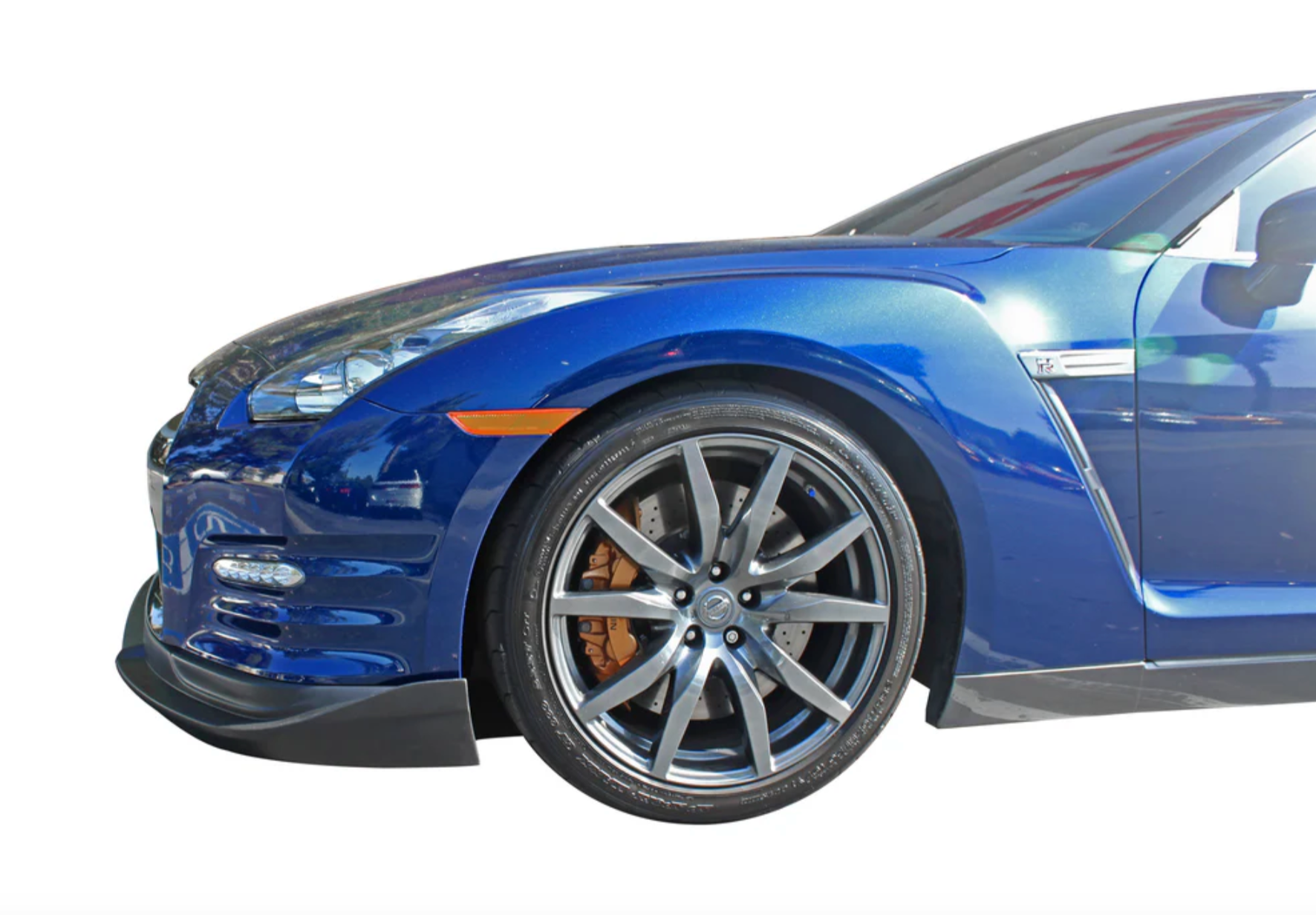 A close up side view of a blue car fitted with Stillen Front Splitter (Urethane) for Nissan GT-R [R35] 2012-2015 on a white background
