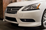 A side close up view of a white car fitted on a car with Stillen Front Lip Spoiler for Nissan Sentra 2013-2015 on a ground