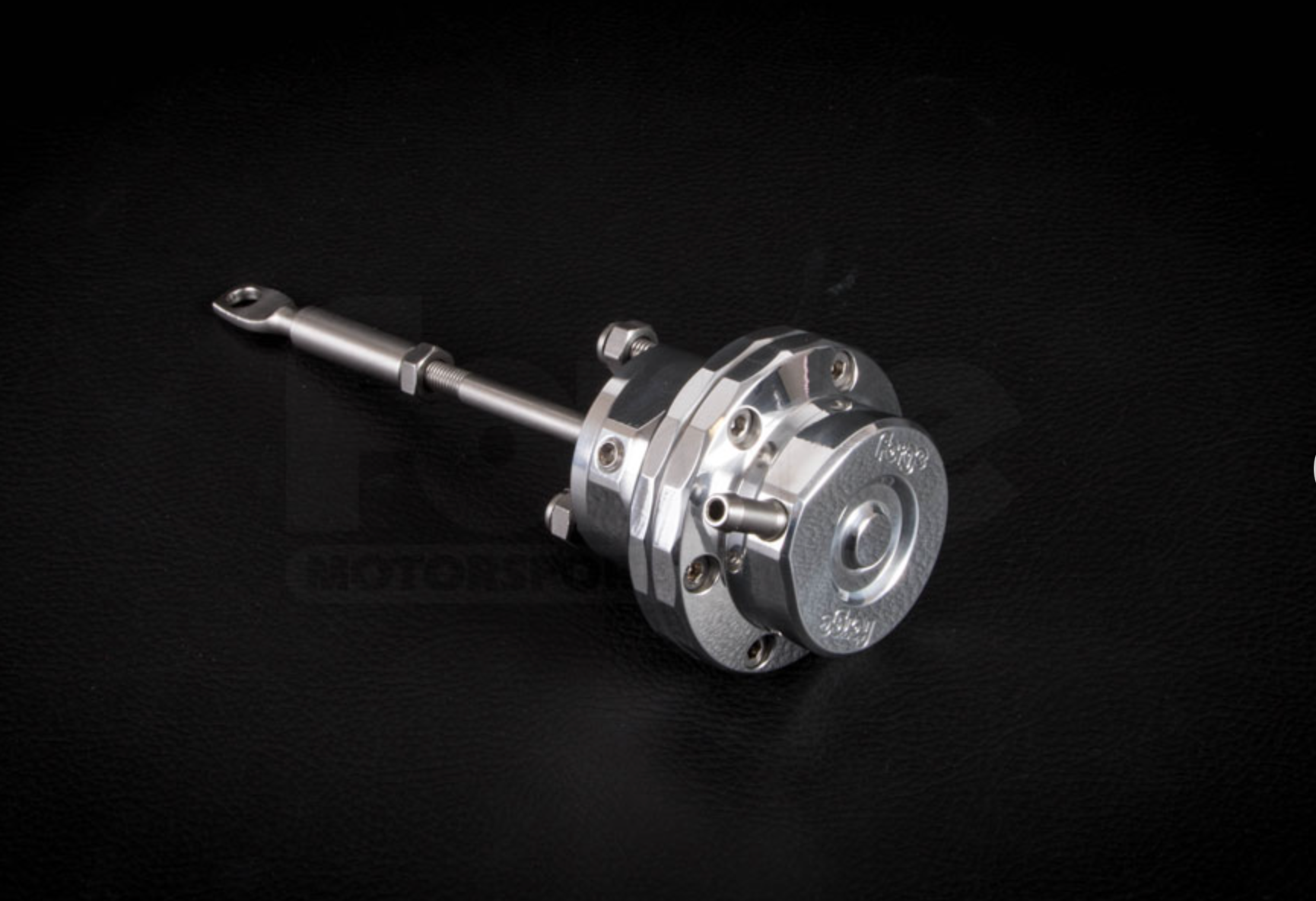 A side top wide view of Forge Motorsport Turbo Actuator for Vauxhall Corsa 1.4T (D / E) 2010-2019 with black background