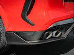 A back close up view of a red car fitted with AutoTecknic Carbon Fiber Rear Splitter Set - BMW F96 X6M LCI / Pre-LCI 2020-2025