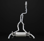 A complete stainless steel performance exhaust system featuring a single downpipe wrapped in silver mesh heat shielding that connects to a long mid-pipe section, which branches into dual pipes leading to a large central rear muffler encased in a textured silver thermal shield and terminating in dual exhaust outlets.