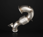 Matte stainless steel IPE performance downpipe featuring an integrated high-flow catalytic converter, sensor bungs, and precision welds on a black background.