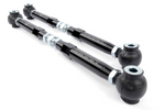 A close-up view of one end of a silver metal toe link, showing a spherical rod end threaded into a hexagonal rod, secured by a silver locking nut.