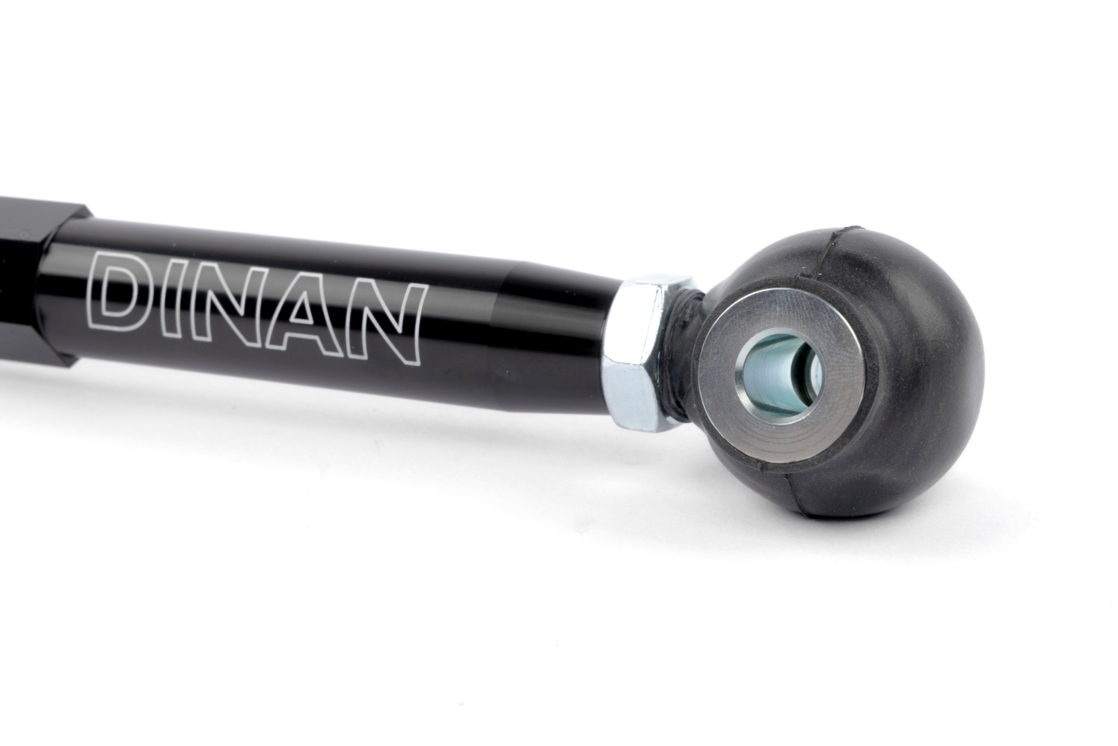 A detailed view of the opposite end of the toe link, featuring a U-shaped silver metal mounting bracket attached to the hexagonal rod with a silver locking nut.
