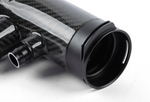 A front-facing view of the wider opening of the carbon fiber turbo inlet pipe, showing the interior and the thickness of the carbon fiber walls.
