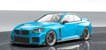 A side wide view of Vorsteiner VRS BMW G87 M2 Aero Front Spoiler Carbon Fiber PP 2x2 Glossy fitted on blue car