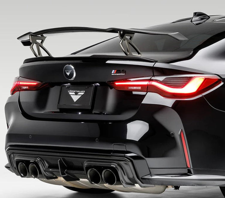 A back view of Copy of Vorsteiner VRS BMW G87 M2 Aero Wing Blade w/ Matte Black Uprights Carbon Fiber PP 2x2 Glossy *Additional hardware required* fitted on a black car