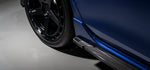 A close up view of a blue car fitted with Urban Automotive Carbon Fiber Side Skirts Volkswagen Golf R Mk8 2020+ on the ground