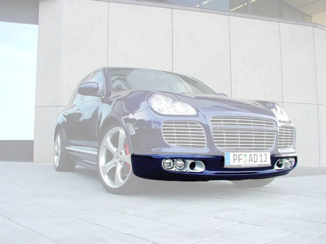 A wide front view of TECHART Front spoiler I for Porsche 955 Cayenne Turbo on a blue Porsche with spoiler highlighted