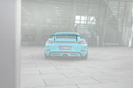 A wide back view of TECHART Rear Spoiler II for Porsche 718 Cayman fitted on a blue car with the spoiler highlighted