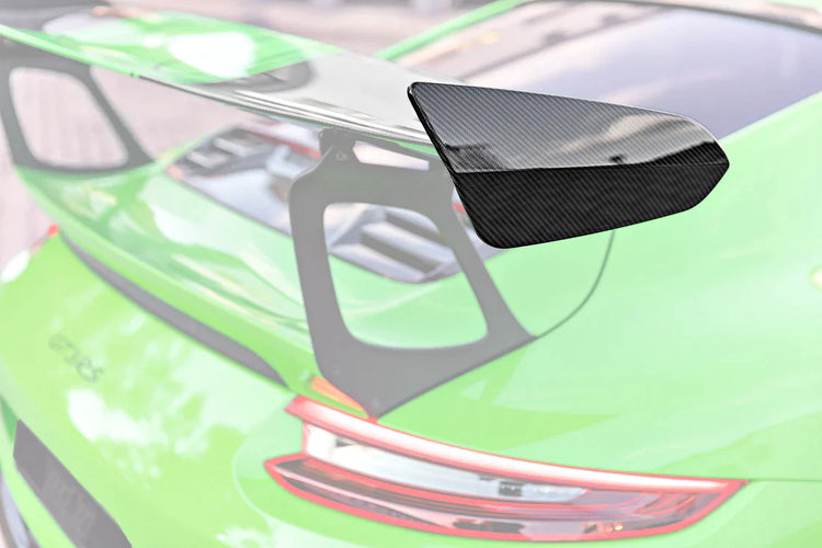 A close up view of TECHART Rear Spoiler Panels Carbon "matte" for Porsche 991.2 GT3 RS from MY18 fitted on a green car with the spoiler highlighted