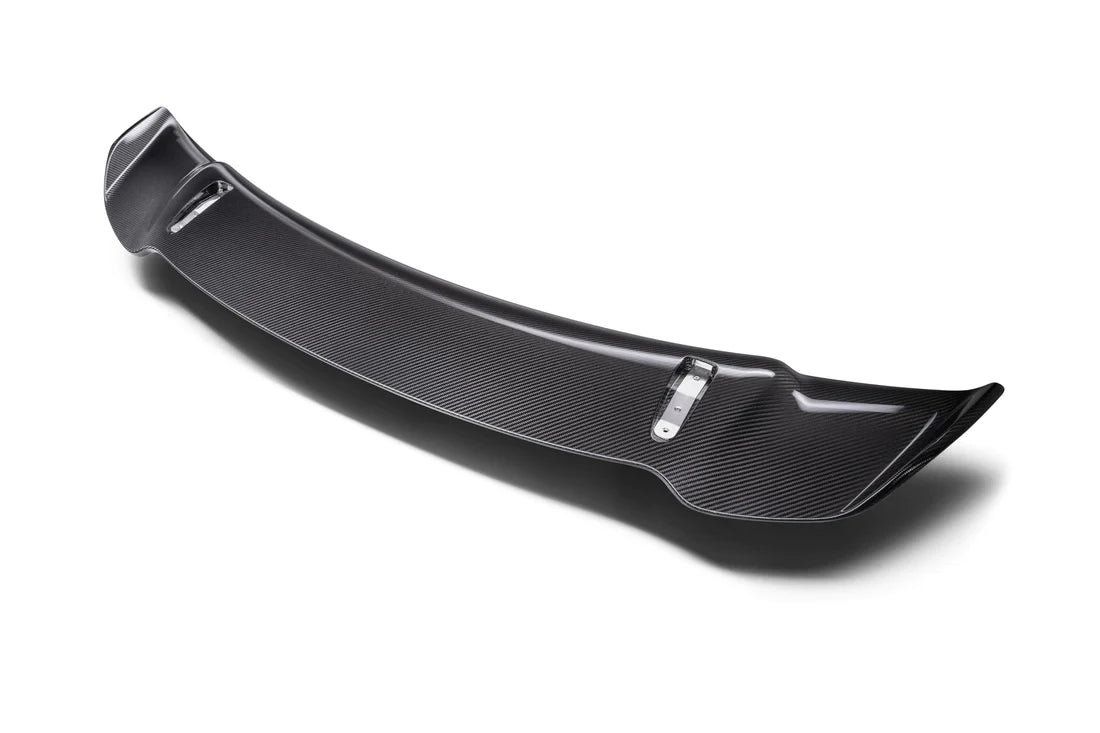 A top view of TECHART Rear Spoiler I Carbon "glossy" for 992 Turbo (S) Coupé from the back with white background