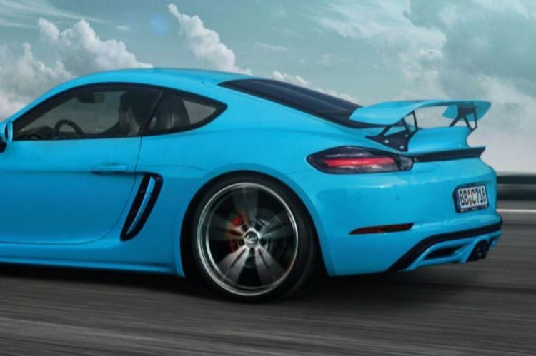 A side view of TECHART Trim Bars for Air Channels Porsche 718 Cayman / Boxster fitted on a blue car