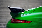 A close up view of TECHART Rear Spoiler II Porsche 991.2 Carrera / Targa from the back fitted on a green car