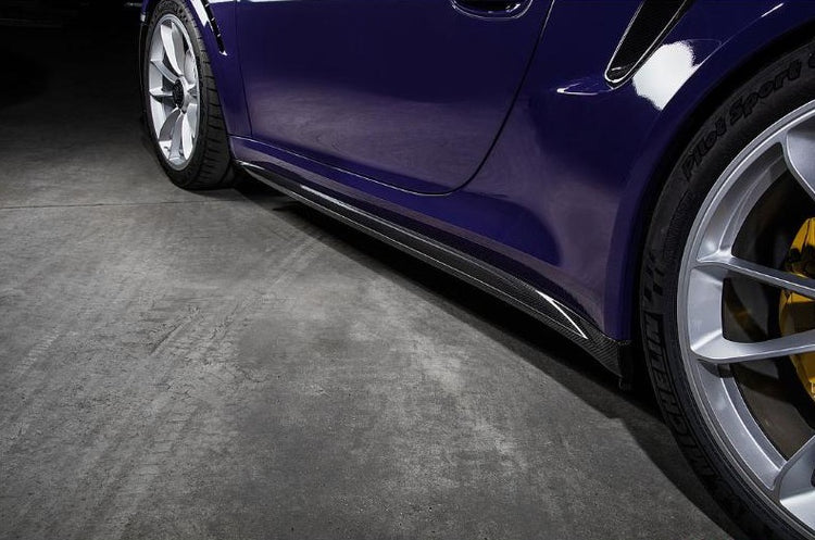 A close up view of TECHART Side Skirt Panels Glossy Carbon Fiber Porsche 991 Turbo / S fitted on a car