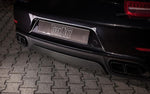 A close up view of TECHART Rear Diffuser Matt Carbon Fiber Porsche 991.1 Carrera / Targa fitted on a black Porsche