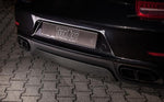 A close up view of TECHART Rear Diffuser Glossy Carbon Fiber Porsche 991.2 Carrera / Targa fitted on a black Porsche