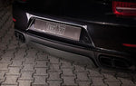 A close up back view of TECHART Rear Diffuser Matt Carbon Fiber Porsche 991.2 Turbo / S fitted on a black Porsche