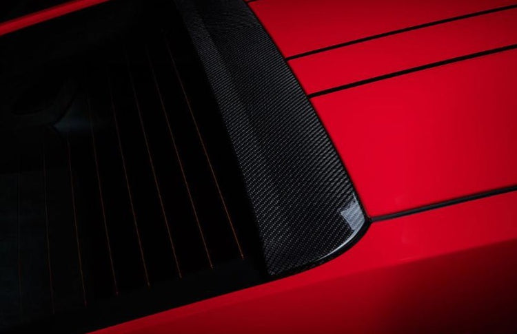 A top view of TECHART Roof Spoiler V-Design Glossy Carbon Fiber Porsche 991.2 GT3 / RS fitted on a red car