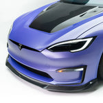 A close up view of a car from the side fitted with Vorsteiner VRS Plaid Aero Front Spoiler Carbon Fiber PP 2x2 Glossy for Tesla Model S 2021+ with a white background
