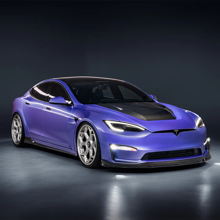 A side wide view of a car fitted with Vorsteiner VRS Plaid Aero Side Skirts Carbon Fiber PP 2x2 Glossy for Tesla Model S 2021+ with grey background