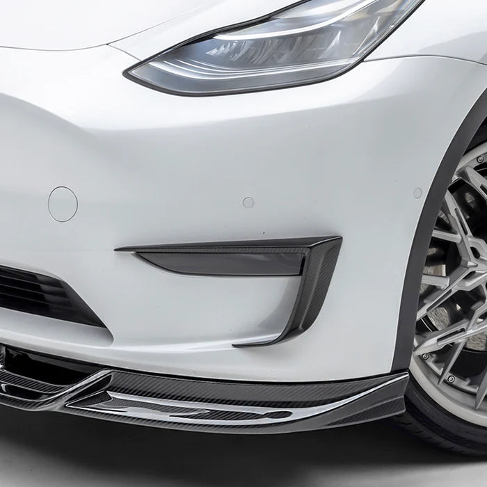 A close up view of Vorsteiner VRS Add-On Aero Bumper Flares Carbon Fiber PP 2x2 Glossy on a white car (for Model Y).