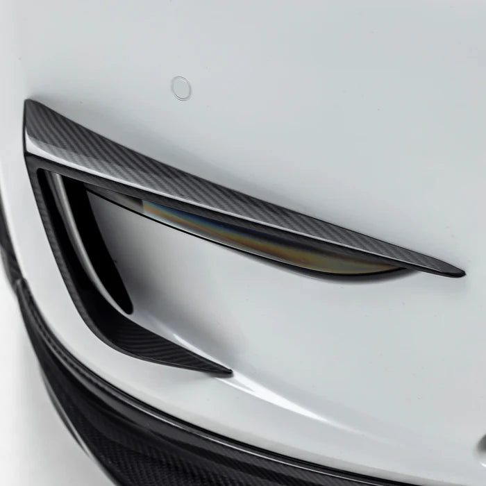 A close up view from the side of Vorsteiner VRS Add-On Aero Bumper Flares Carbon Fiber PP 2x2 Glossy on a white car (for Model Y).