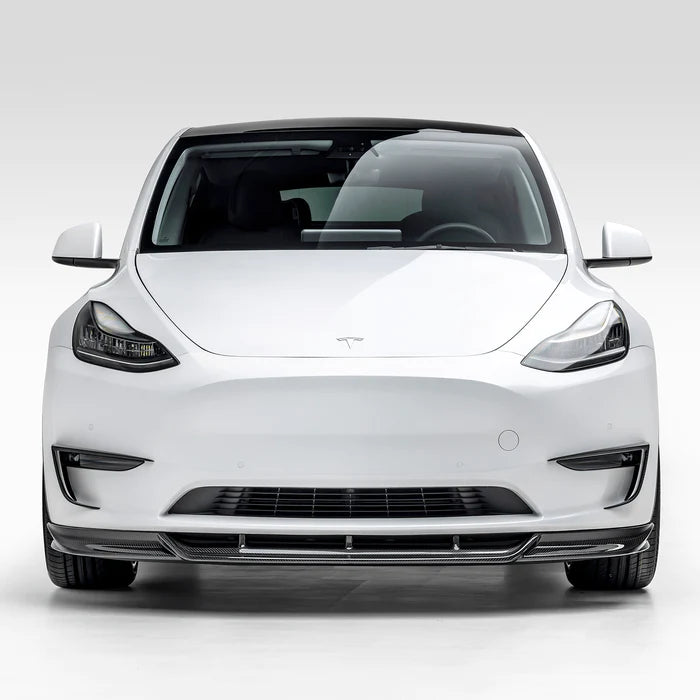 A wide view of Vorsteiner VRS Add-On Aero Bumper Flares Carbon Fiber PP 2x2 Glossy on a white car from the front (for Model Y).