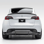 A wide view of Vorsteiner VRS Aero Decklid Spoiler Carbon Fiber PP 2x2 Glossy fitted on a white car from behind (for Model Y).