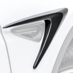 A close up view of Vorsteiner VRS Add-On Aero Fender Vents Carbon Fiber PP 2x2 Glossy on a white car (for Model Y). 