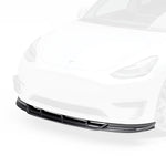 A close up view of Vorsteiner VRS Aero Front Spoiler Carbon Fiber PP 2x2 Glossy on a white car from the front (for Model Y).