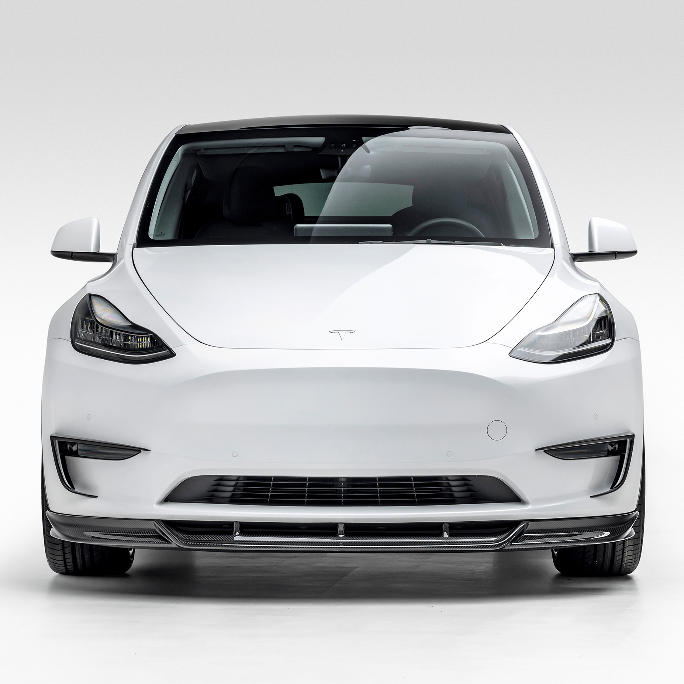 White Model Y with full aero program, head-on view