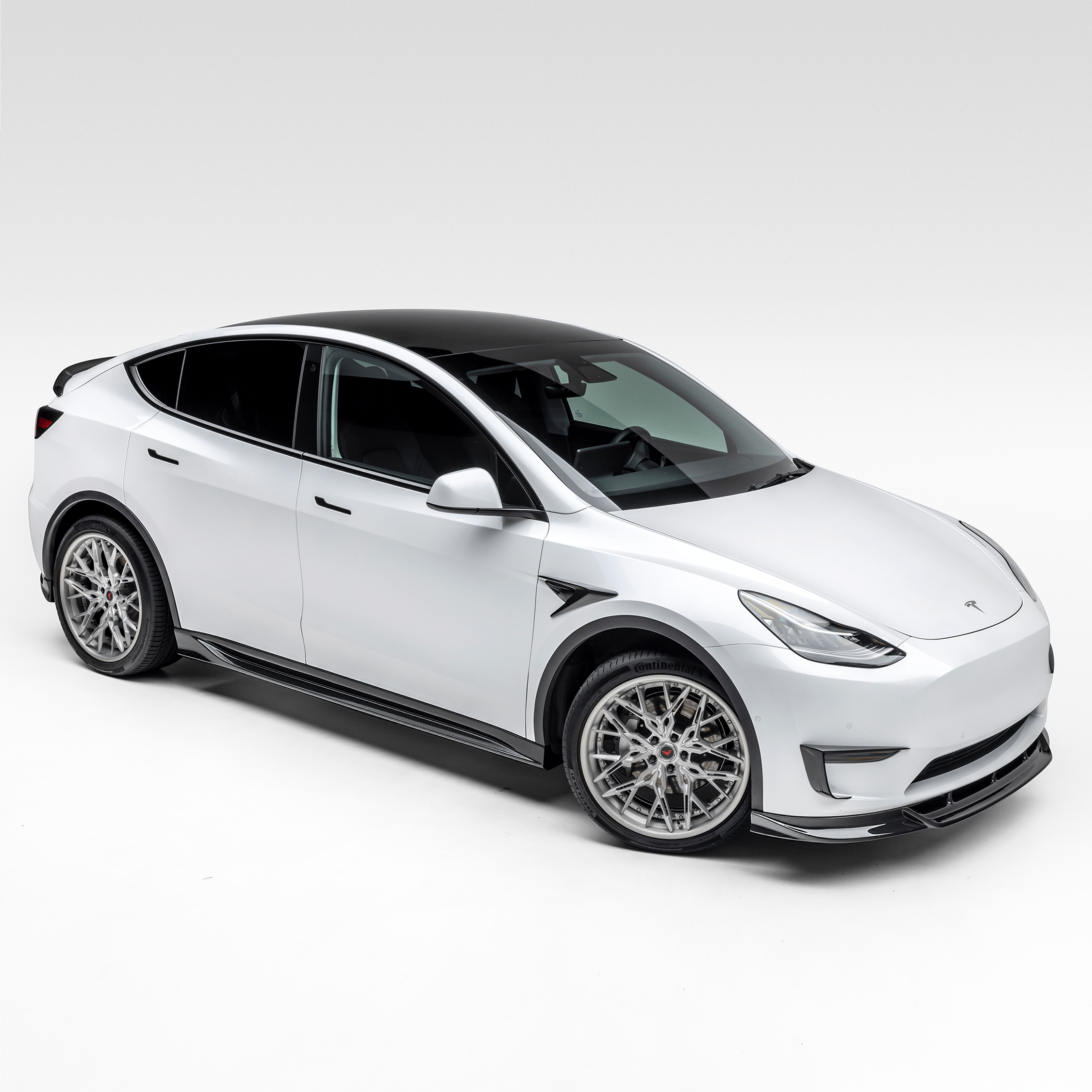 White Model Y with full aero program, high front 3/4 view